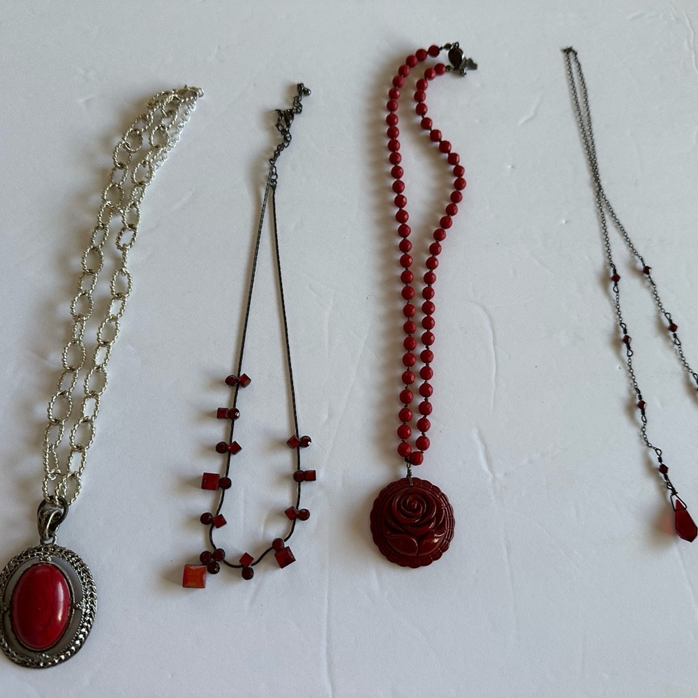 Lot of four red costume jewelry necklaces